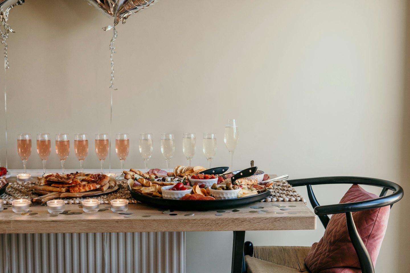 A festive dining table is set with appetizers and champagne.