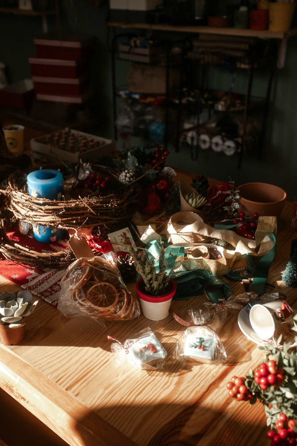 Christmas crafting supplies arranged on a rustic wooden table.