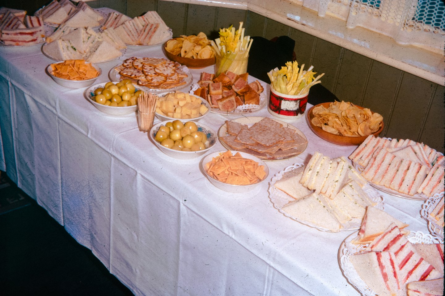 Buffet table filled with party foods and finger foods indoors.